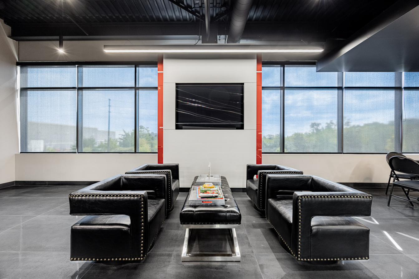 Second-floor seating area with TV and windows.