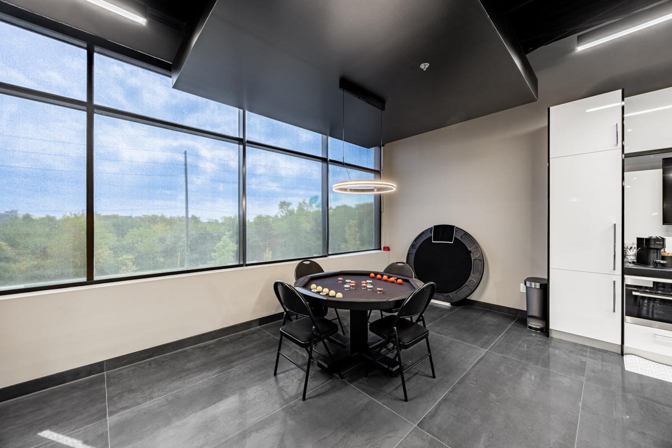 Second-floor card table near the windows.